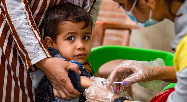 یک کودک در 26 اکتبر 2022 واکسن را از یکی از کارکنان بخش بهداشت در محله غویران، شهر حسکه، شمال شرق سوریه دریافت کرد.